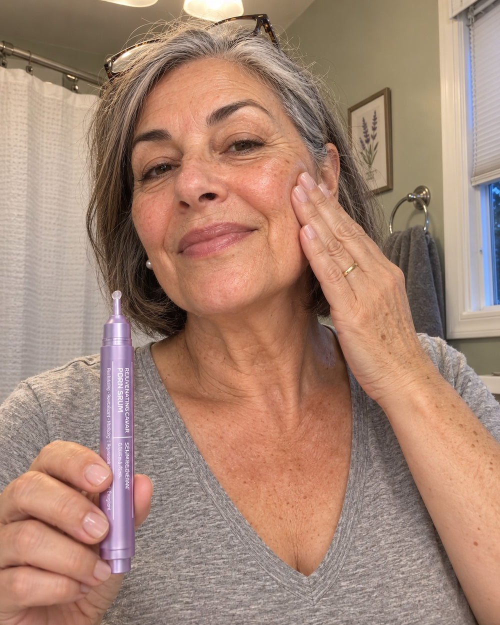Customer pressing serum into her cheek, holding the pen
