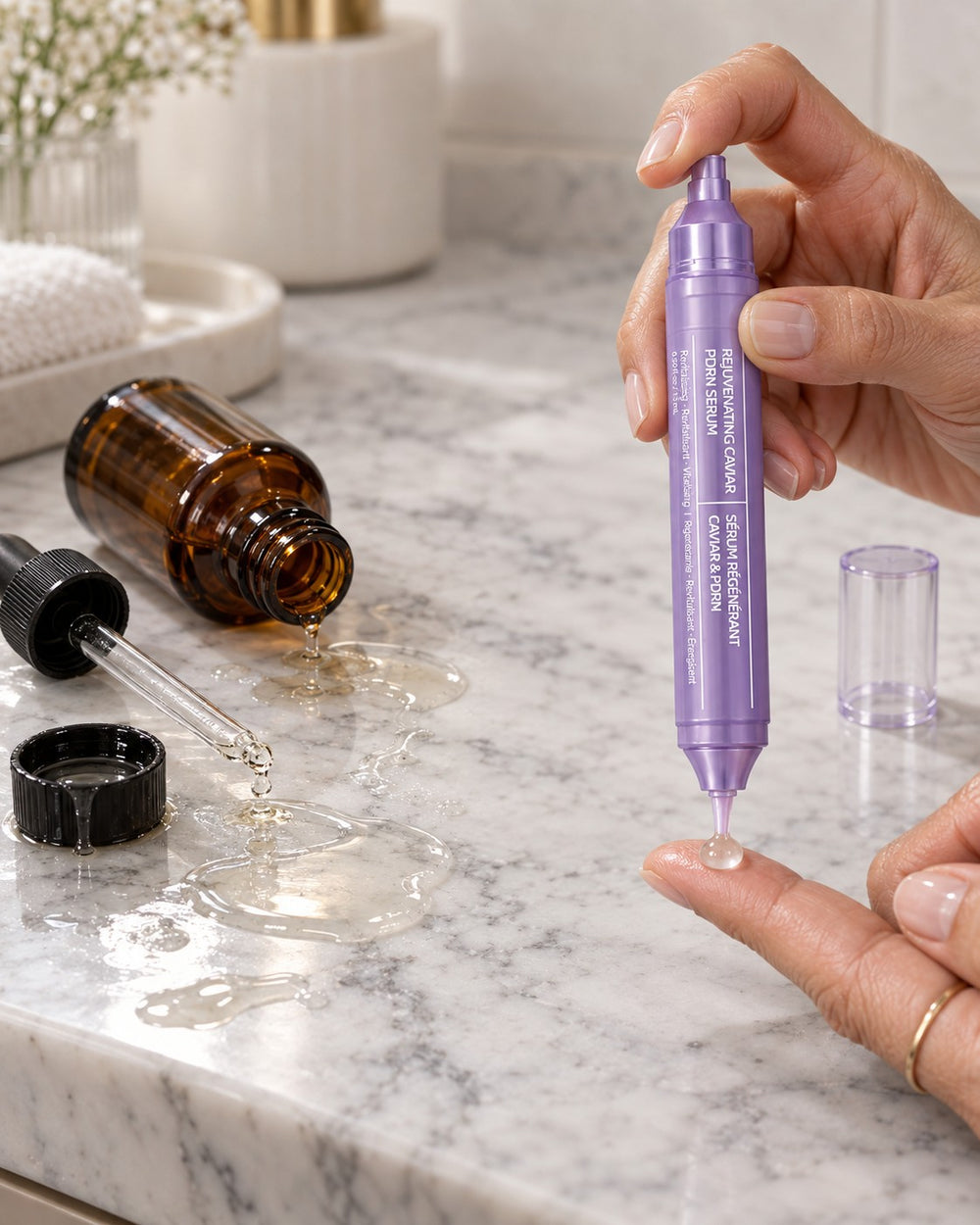 Spilled dropper serum beside the Sylvie pen dispensing one measured bead