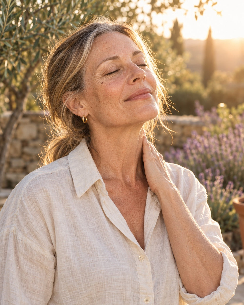 Woman in her 50s outdoors in linen, relaxed